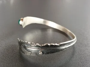 Detailed angled view of the handmade Still Point sterling silver bracelet with a polished green onix.