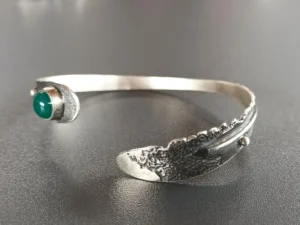 andmade sterling silver Still Point bracelet viewed from an angled perspective with green onix.