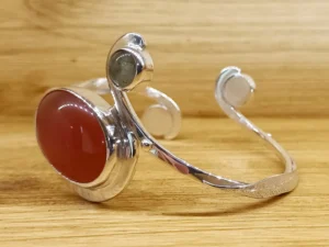 Angled view of the Last Light contemporary sterling silver bracelet with carnelian.