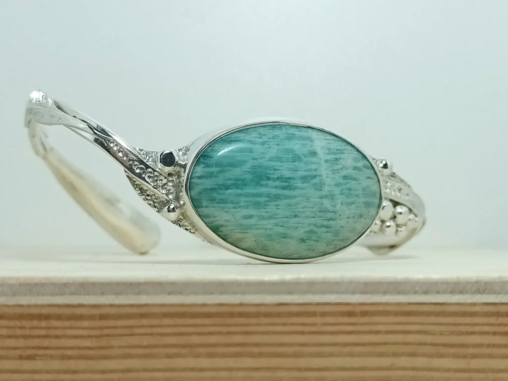 Front angle view of the Between contemporary sterling silver bracelet with amazonite.