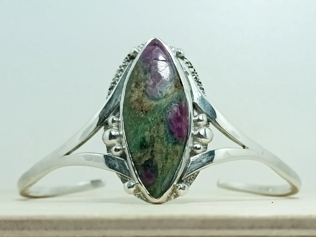 Front view of the Still Growing contemporary sterling silver bracelet with ruby zoisite.