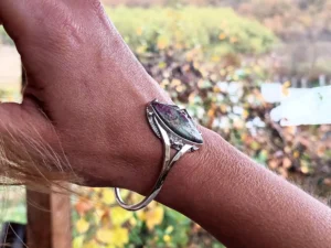 Still Growing contemporary sterling silver bracelet worn on the hand.