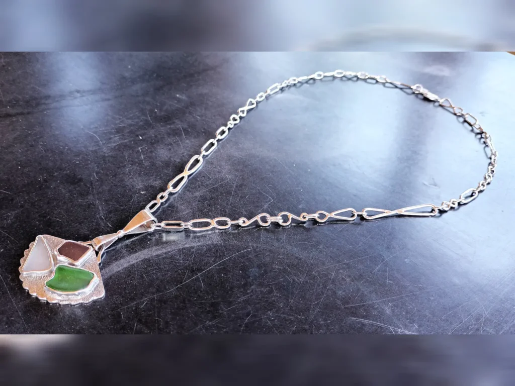 What Remains contemporary sterling silver necklace featuring genuine sea glass